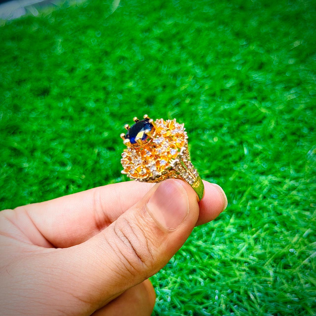 Big gold plated ring with dark blue stone