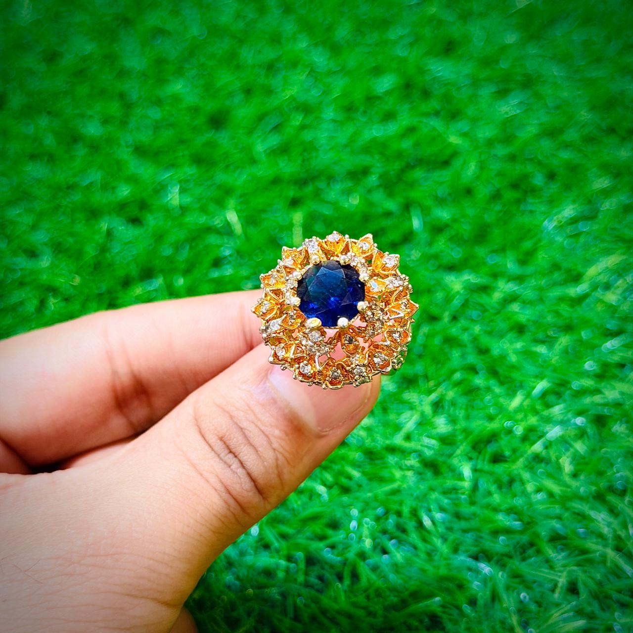 Big gold plated ring with dark blue stone