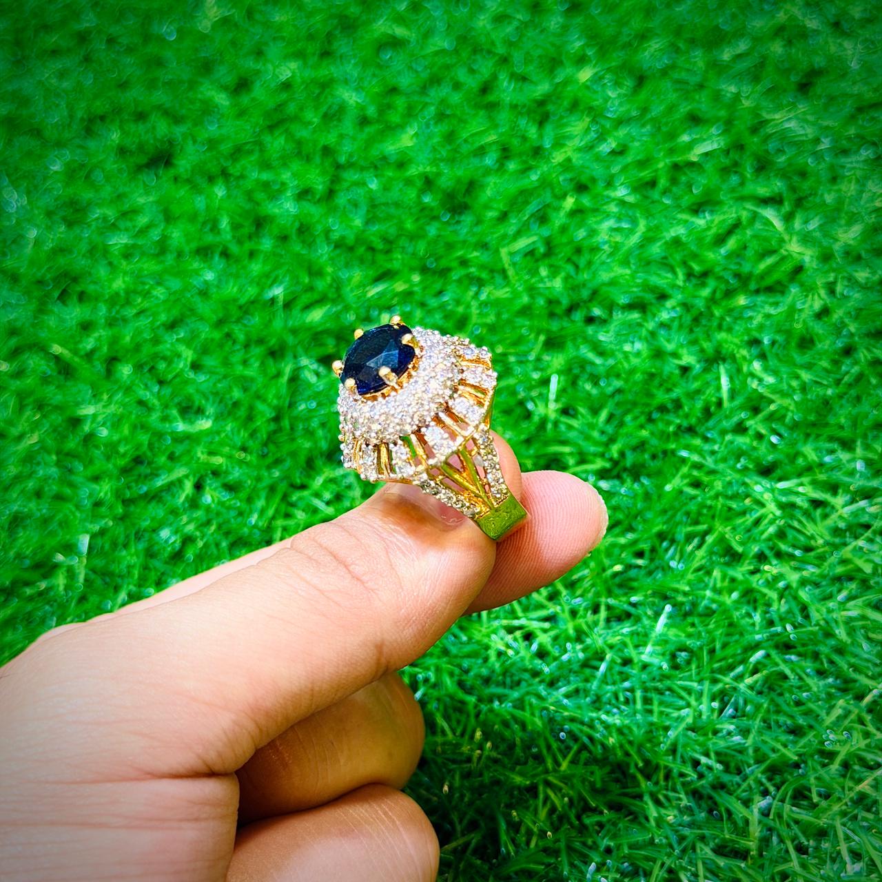 Gold plated ring with dark blue stone