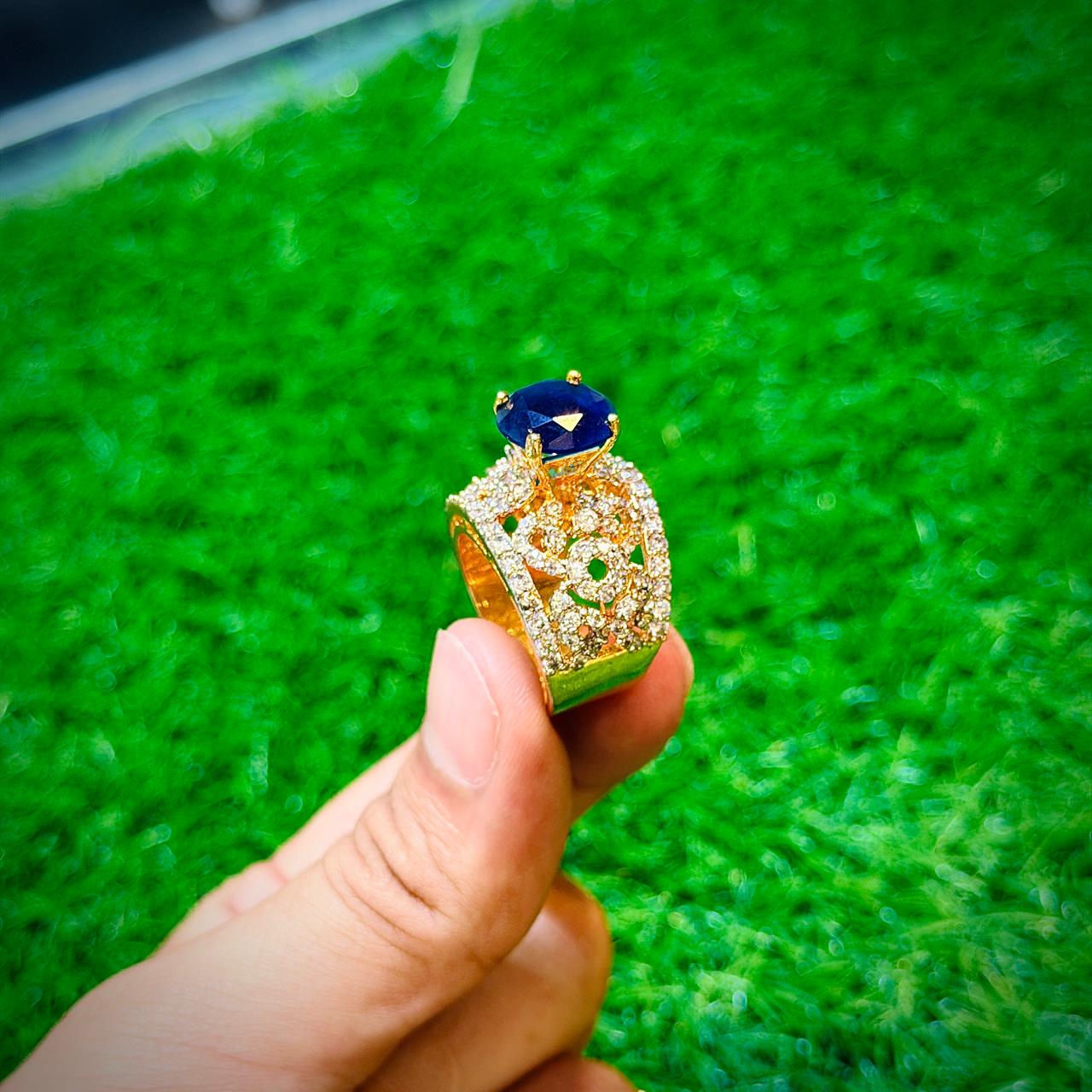 Gold plated ring with dark blue stone