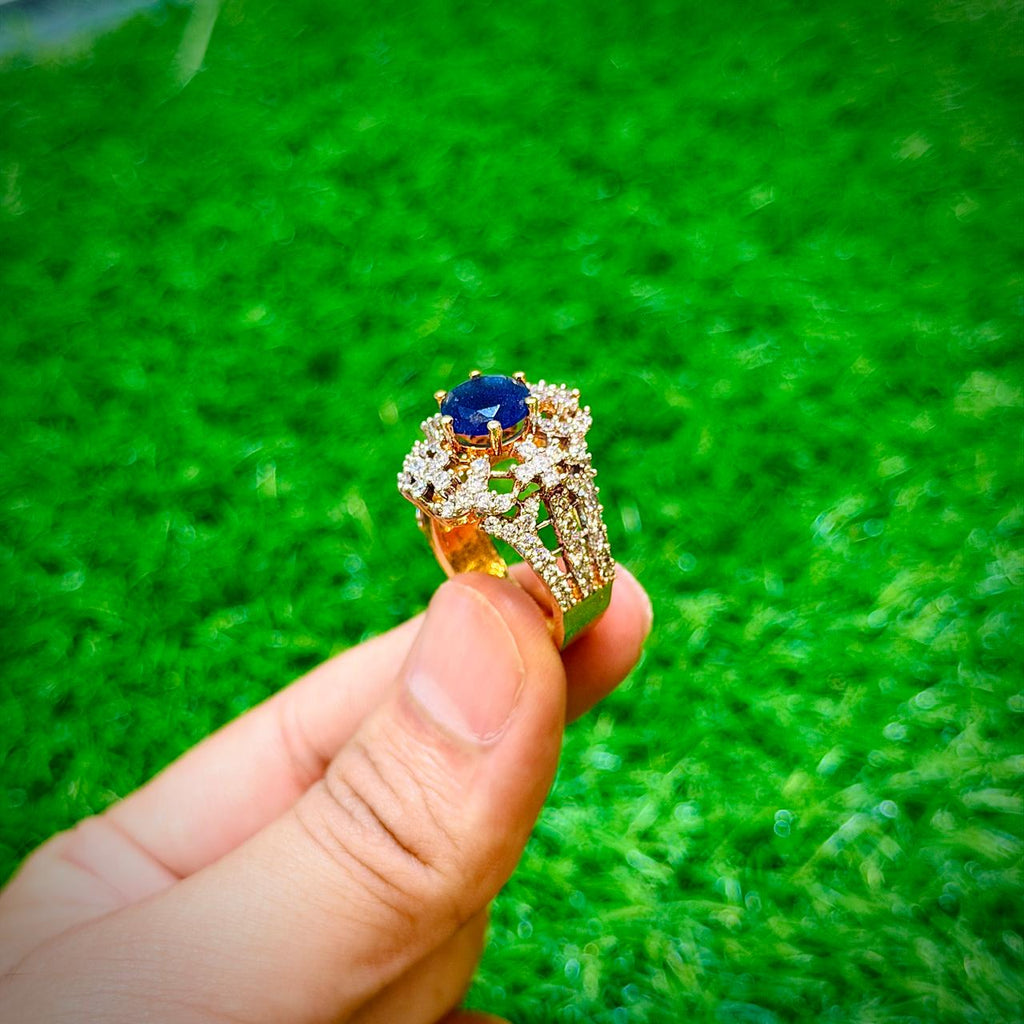 Gold plated ring with dark blue stone