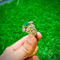Gold plated ring with square emerald green stone