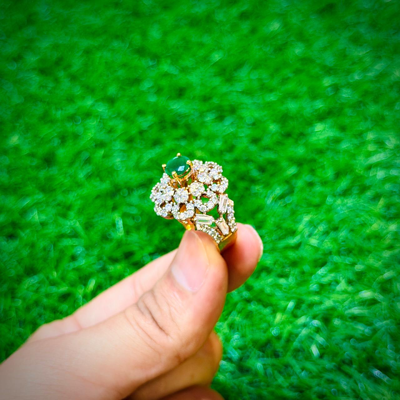 Gold plated ring with small emerald green stone